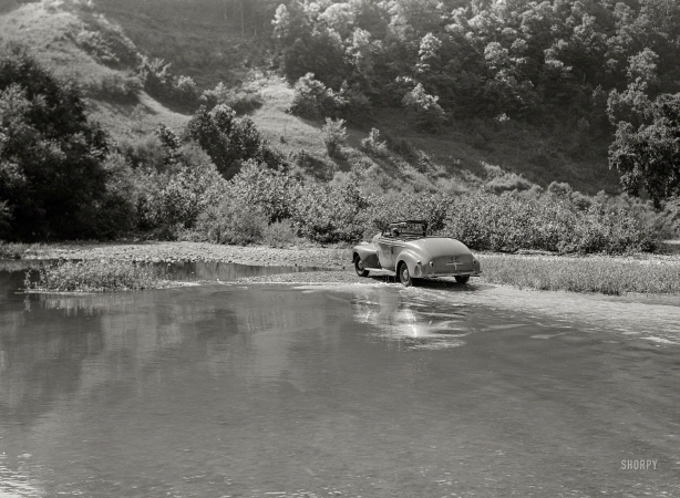 Photo showing: I Auto Be in Pictures -- September 1940. Car fording creek up Morris Fork of the Kentucky River.
Photographer Marion Post Wolcott in her Oldsmobile.