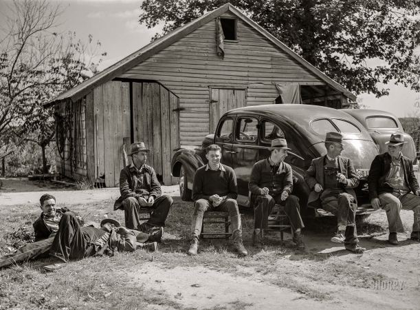 Photo showing: Shuck Buddies -- October 1940. Resting after dinner following a corn shucking on
Hooper Farm in Corbett Ridge section. Caswell County, North Carolina.