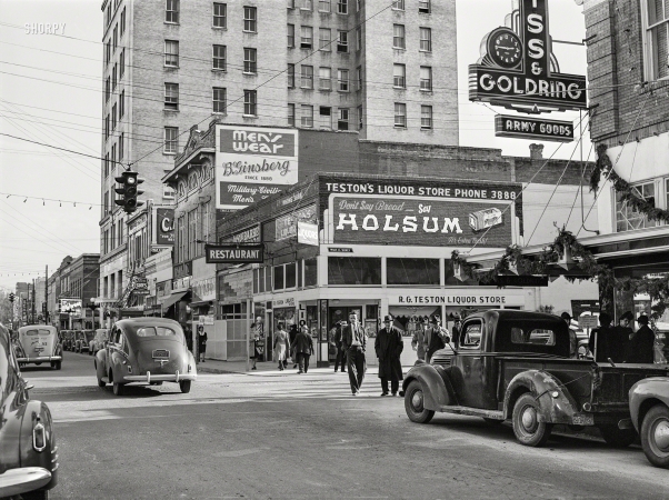 Photo showing: Army Goods -- December 1940. Signs in Alexandria, Louisiana, advertising military wearing apparel and goods.