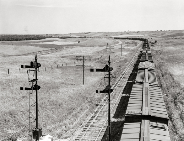 Photo showing: Across the Plains -- August 1941. Freight train going west from Minot, North Dakota, across the plains.