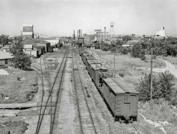 Photo showing: Magical Minot -- August 1941. Minot, North Dakota. Rail yard and grain elevators.