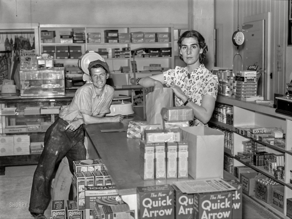 Photo showing: Quick Arrow -- September 1938. Buying groceries in community store. Tygart Valley, West Virginia.