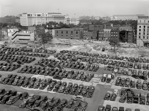 Photo showing: Government Parking -- July 1939. Washington, D.C. Parking lot for government employees, and buildings being torn down to make room for parking lot.