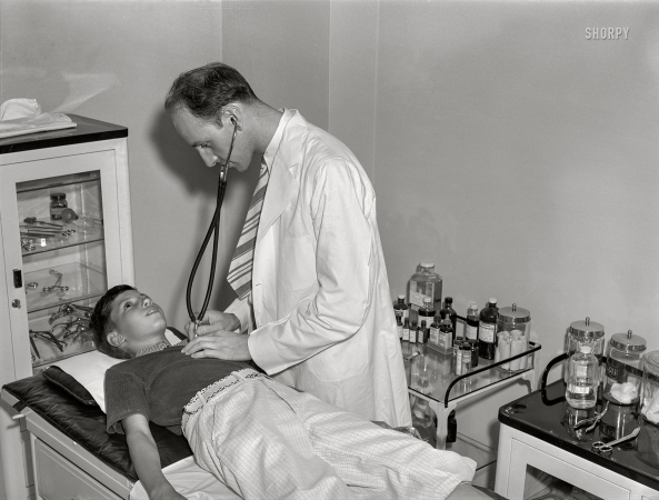 Photo showing: The Auscultation -- September 1939. Boy being examined by doctor. Greendale, Wisconsin.