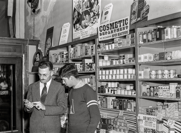 Photo showing: Expert Advice -- September 1939. Graceville, Minnesota. High school boy talking to druggist.