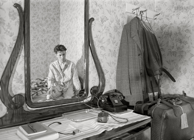 Photo showing: Self-Portrait in PJs -- April 1940. Photographer John Vachon in a hotel room in Dubuque.