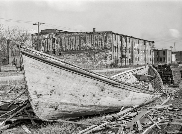 Photo showing: A.A. Cooper Wagon and Buggy Co. -- April 1940. Abandoned boat along Mississippi River waterfront. Dubuque, Iowa.
