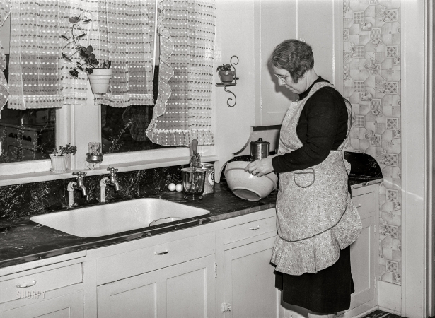 Photo showing: Baked a Cake -- April 1940. Wife of Iowa farmer starting to make a cake. Greene County, Iowa.