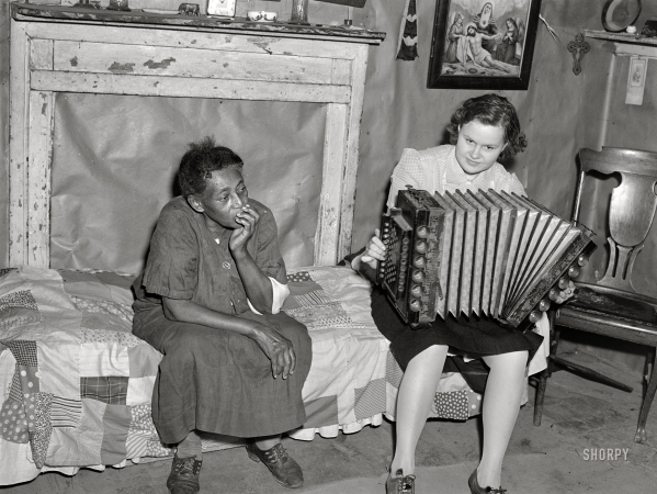 Photo showing: Get the Party Started -- 1940. St. Mary's County, Maryland. Louise Dyson and guest playing Mr. Dyson's accordion. 