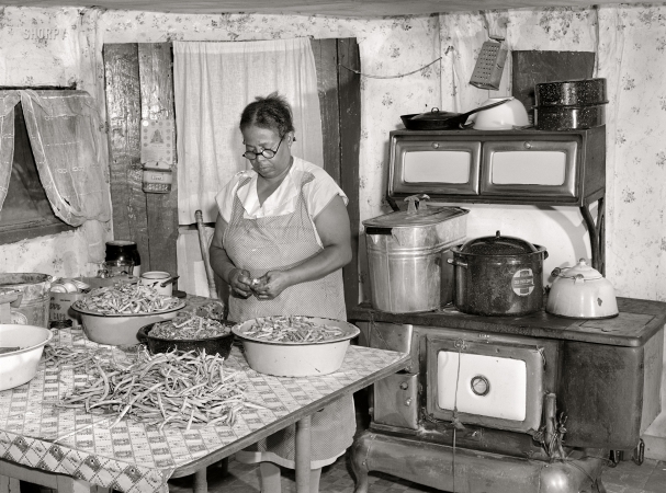 Photo showing: Hill of Beans -- September 1940. Saint Mary's County, Maryland. Mrs. Eugene Smith, FSA borrower, canning string beans.