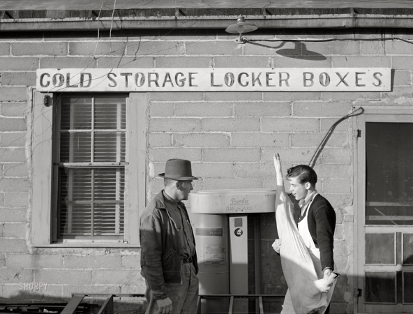 Photo showing: Porksicle -- October 1940. Cooperative cold storage lockers in Casselton,
North Dakota, where farmers bring their own butchered pigs.