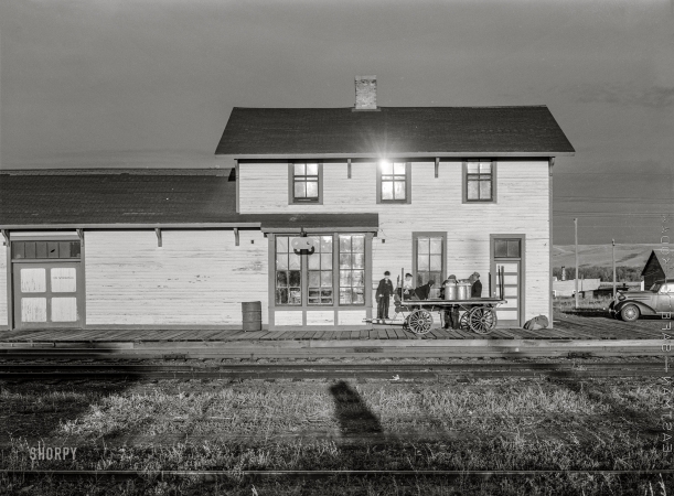 Photo showing: Milk Runners -- October 1940. Train depot in Burlington, North Dakota.