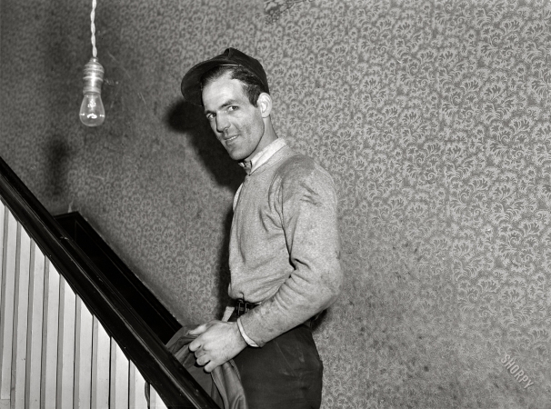 Photo showing: Powder Roomer -- December 1940. Radford, Virginia. Hercules Powder Plant employee
going upstairs. Mrs. Pritchard's boardinghouse. Eighteen men board here.