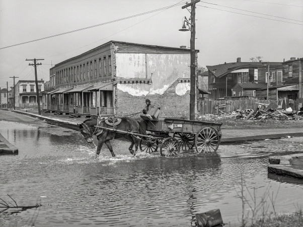 Photo showing: Canal Street -- March 1941. Backed up storm sewer in Negro slum district. Norfolk, Virginia.