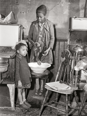 Photo showing: Home Laundry -- March 1941. Daughters of defense worker. Negro slum district. Norfolk, Virginia.