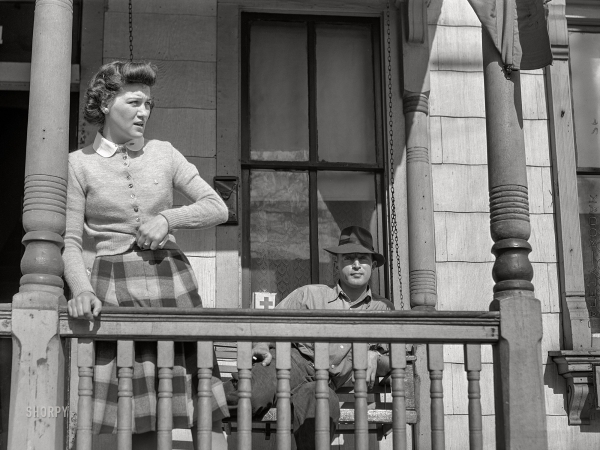 Photo showing: Porch Swinger -- March 1941. Front porch of rooming house. Portsmouth, Virginia.