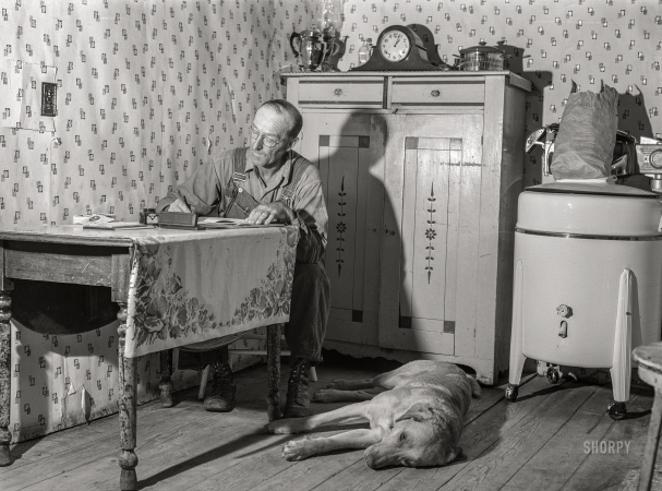 Photo showing: Home Office. -- August 1941. FSA borrower working on accounts. Itasca County, Minnesota.