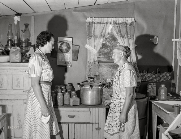 Photo showing: Pressure Cookers -- July 1941. Wife of FSA borrower discussing pressure cooker with home supervisor. Mille Lacs County, Minnesota.