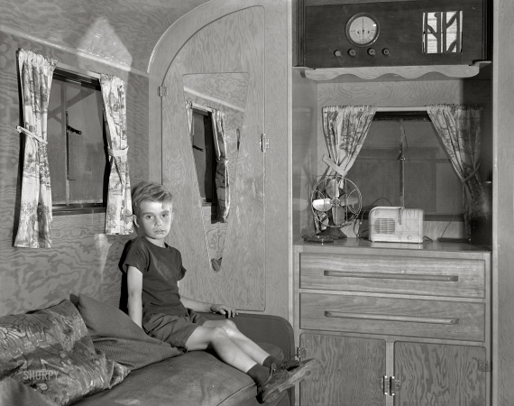 Photo showing: Little Boy Blue II -- August 1941. Son of Mr. Nichols, defense worker from Cass City,
Michigan, now living in a trailer at Edgewater Park near Ypsilanti.