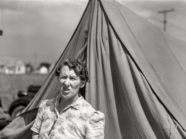 Photo showing: Meet Mrs. Ash -- August 1941. Mrs. Ash, wife of defense worker, living in a tent
beside the foundation of their new home. Outskirts of Detroit, Michigan.