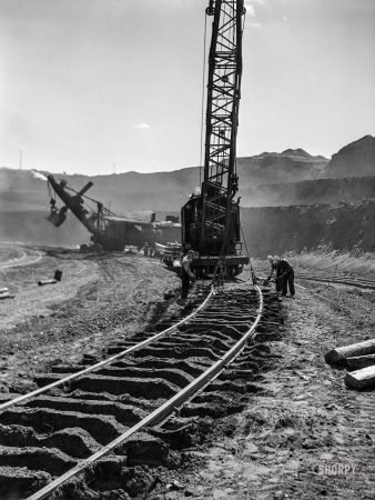 Photo showing: Fresh Tracks -- August 1941. Moving railroad track in the Mahoning pit. Hibbing, Minnesota.