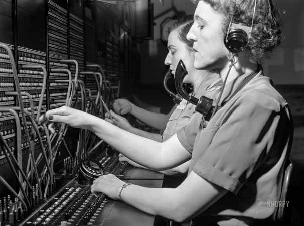 Photo showing: Plugged In -- December 1941. Telephone operators at Aberdeen proving grounds.
They live in dormitory for defense workers. Aberdeen, Maryland.