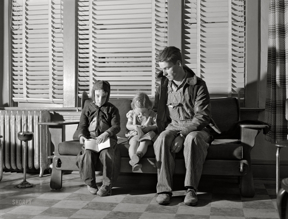 Photo showing: Once Bitten -- February 1942. Chafee, Missouri. Waiting to see the doctor. The little girl
was bitten by a dog and is to receive anti-hydrophobia injections.