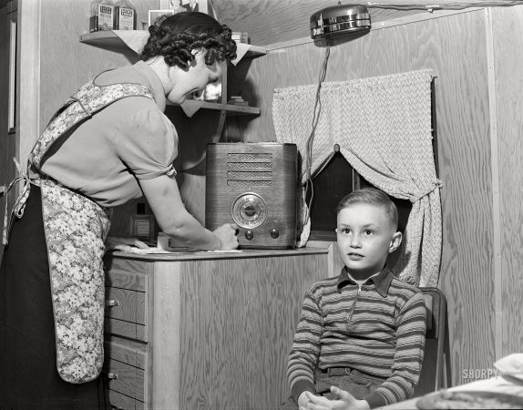 Photo showing: Raised on Radio. -- February 1942. Burlington, Iowa. Sunnyside unit. In a trailer for workers at the Burlington ordnance plant.