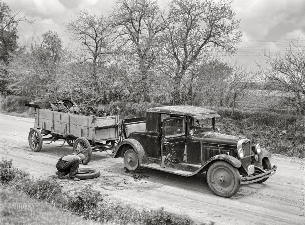 Photo showing: Tire, Iron -- May 1942. Kearney, Buffalo County, Nebraska. Farm boy with flat tire,<br  />
which happened while he was bringing a load of scrap iron to town.