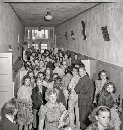 Photo showing: Student Bodies -- September 1941. Hermiston, Oregon. Crowded halls in high school between classes.