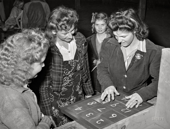Photo showing: By the Numbers -- February 1942. Tulare County, Calif. FSA farm workers' camp. Girls in the recreation room.