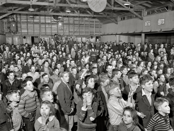 Photo showing: Movie Night -- February 1942. Tulare County, California. FSA farm workers' camp. At the movies.