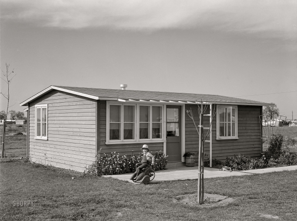 Photo showing: Garden House -- February 1942. Woodville, Calif. FSA farm workers'
community. Son of agricultural worker at their garden house.