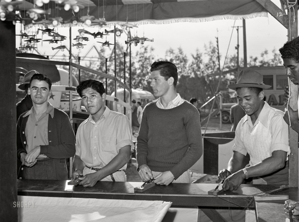 Photo showing: Fair Game -- March 1942. El Centro, California. Boys at carnival attraction. Imperial County Fair.