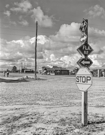 Photo showing: Bustling Baker -- June 1942. Baker, Florida. Crossroads in nearest town to Escambia Farms.