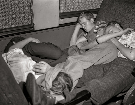 Photo showing: Night Riders -- September 1942. Boys sleeping as best they can on special train from
Richwood, West Virginia, to upper New York state to work in the harvest.