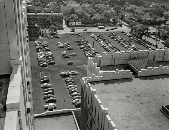 Photo showing: A Lot of Cars -- July 1942. Detroit, Michigan. Looking down on a parking lot from the rear of the Fisher Building.