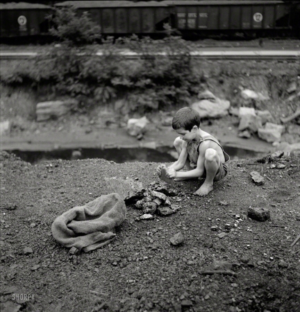 Photo showing: The Carbon Kid -- September 1938. Coal miner's child breaking up large pieces of coal to take home. Pursglove, Scott's Run, West Virginia.