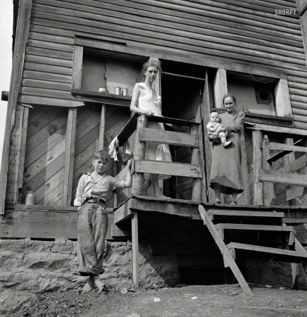 Photo showing: Mountain Mamas -- September 1938.  Wife of unemployed coal miner, suffering from T.B., with her mother and
children. Family living in old company store. Abandoned mining town of Marine, West Virginia.