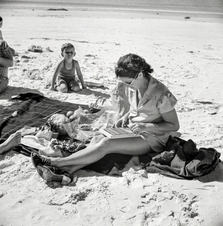 Photo showing: Beach Craft -- January 1941. Guest of Sarasota, Florida, trailer park at the beach with her family.