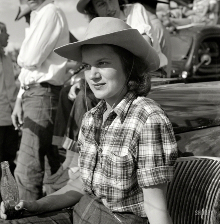 Photo showing: Coca-Cola Cowgirl -- August 1941. Dude from Quarter Circle U Ranch watching the rodeo at the Crow Agency Indian fair. Big Horn County, Montana.