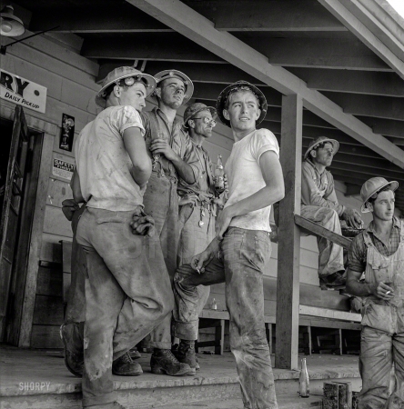 Photo showing: Dam Workmen -- June 1942. Shasta Dam, Shasta County, California. Workmen on porch of com­mis­sary.