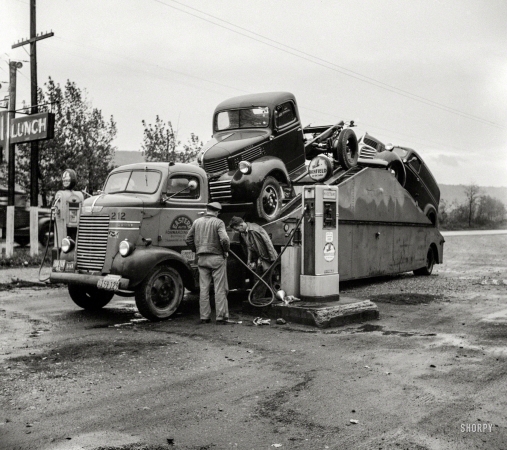 Photo showing: Double Truck -- October 1941. Car transport filling up with gas at Little Falls, New York.