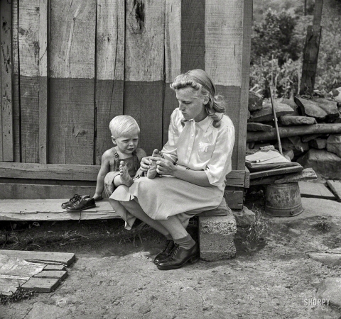 Photo showing: Little Feet -- September 1942. Richwood, West Virginia. Hazel Friend and her son, Darriell, in front of their home.