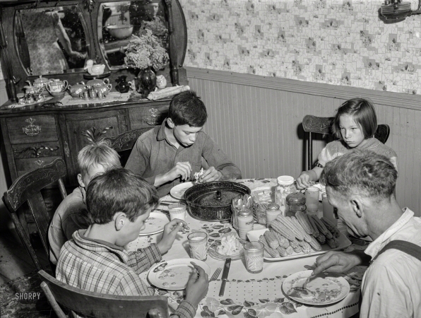 Photo showing: Corn-Fed -- August 1941. Having dinner at the home of Ray Lyman, FSA client near Castleton, Vermont.