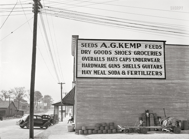 Photo showing: Guns Guitars Groceries -- November 1939. General store. Zebulon, Wake County, North Carolina.
