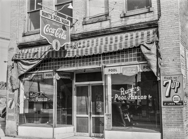 Photo showing: Runts Pool Parlor -- November 1939. Runt's pool parlor with poster advertising
Tobacco Ball in window. Zebulon, Wake County, North Carolina.