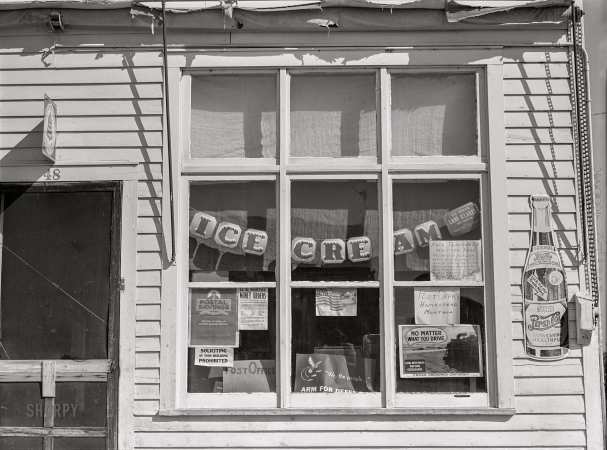 Photo showing: Homestead P.O. -- August 1941. Window of post office and store in Homestead, Montana.