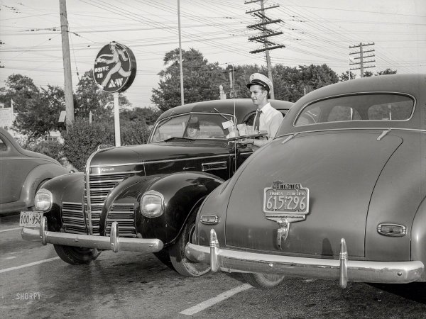 Photo showing: Curb Service. -- July 1942. Chevy Chase, Maryland. Serving supper to motorists at an A&W Hot Shoppes restaurant.