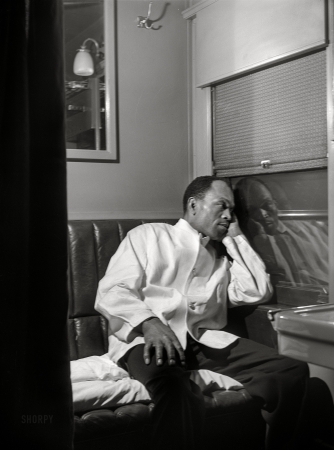 Photo showing: The Night Porter -- March 1942. Alfred MacMillan, Pullman porter resting in the
men's washroom aboard the 'Capitol Limited' bound for Chicago.